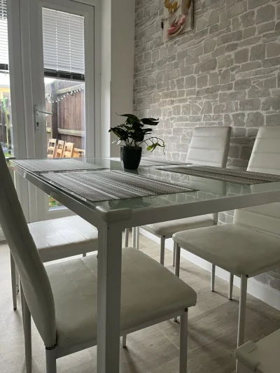 Modern Glass-Top Dining Table with White Chairs — image 2