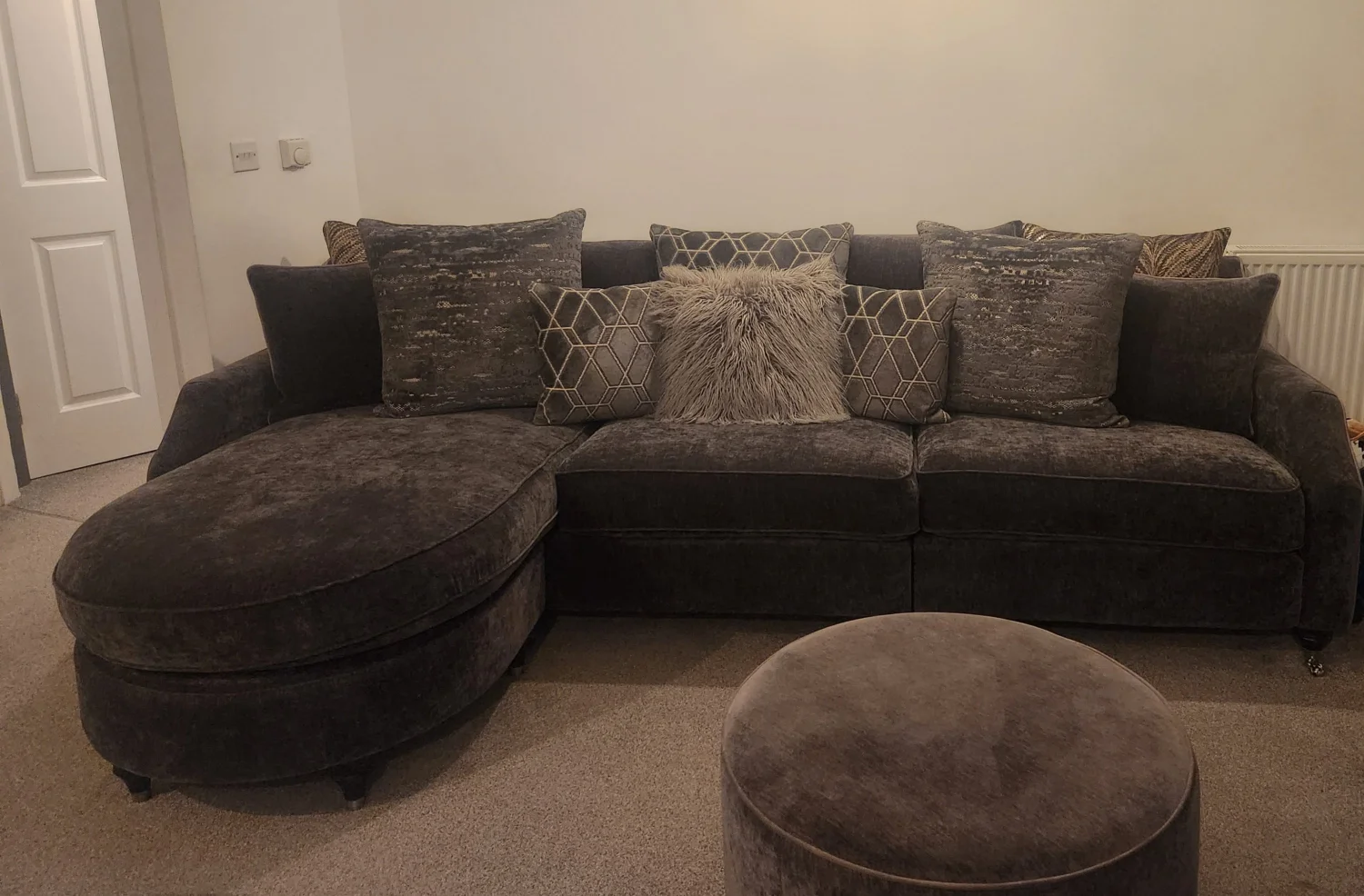 Stylish Modern Grey Sofa with Circular Ottoman and Cushions