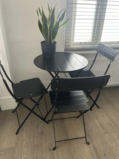 Stylish Modern Bistro Table and Folding Chairs Set in Sleek Black — image 2