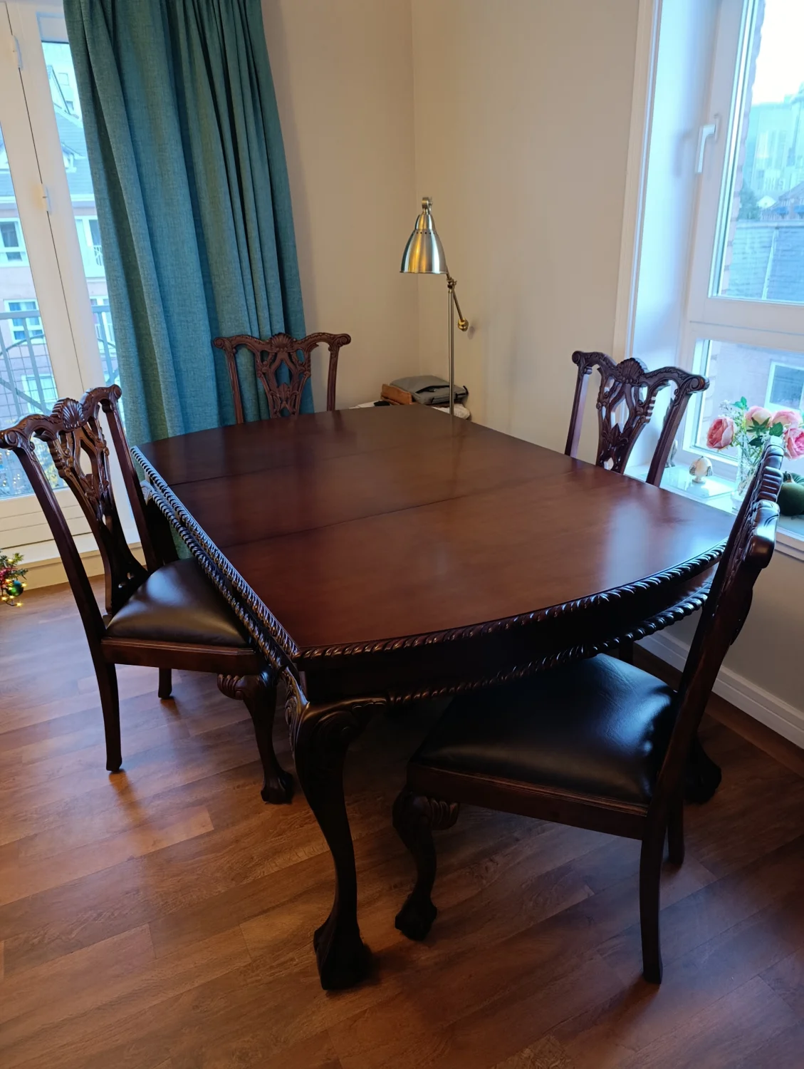 Chippendale-style dining set of an extendable table and four carved chairs