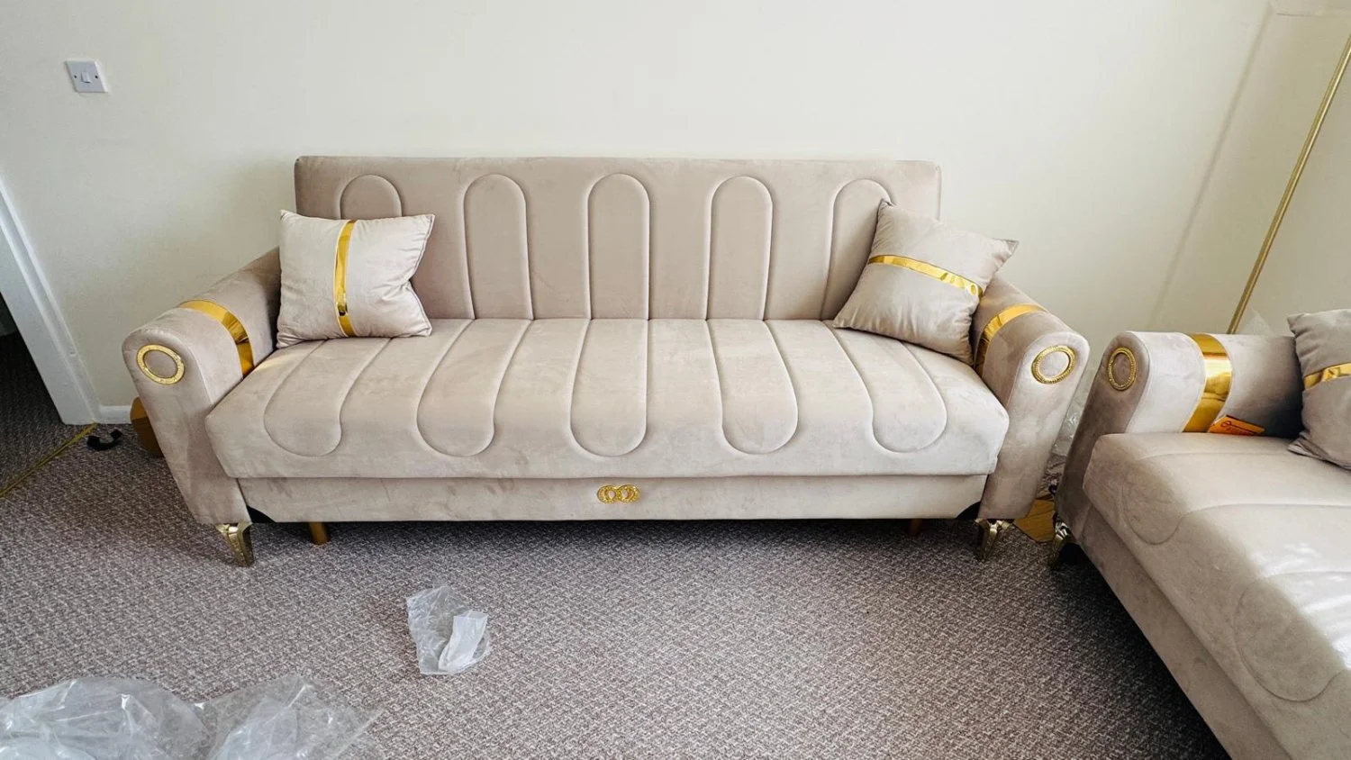 Modern 3-seater sofabed in beige with gold accents