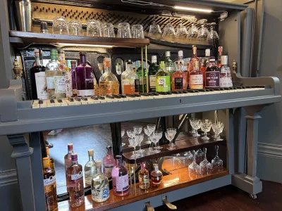 Vintage bar cabinet repurposed from a piano on Furnish Well