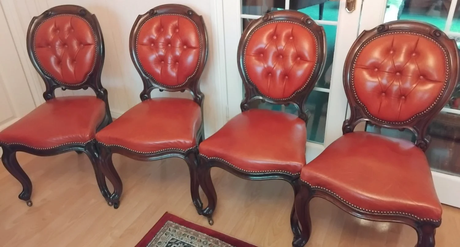 Set of four vintage upholstered dining chairs with ornate wooden frames