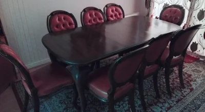 Antique dining table and eight chairs set with red faux leather upholstery