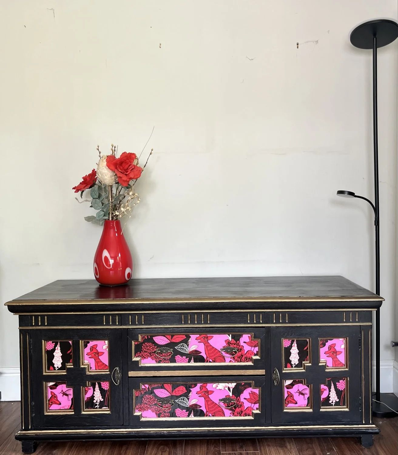 Vintage black storage cabinet with decorative panels