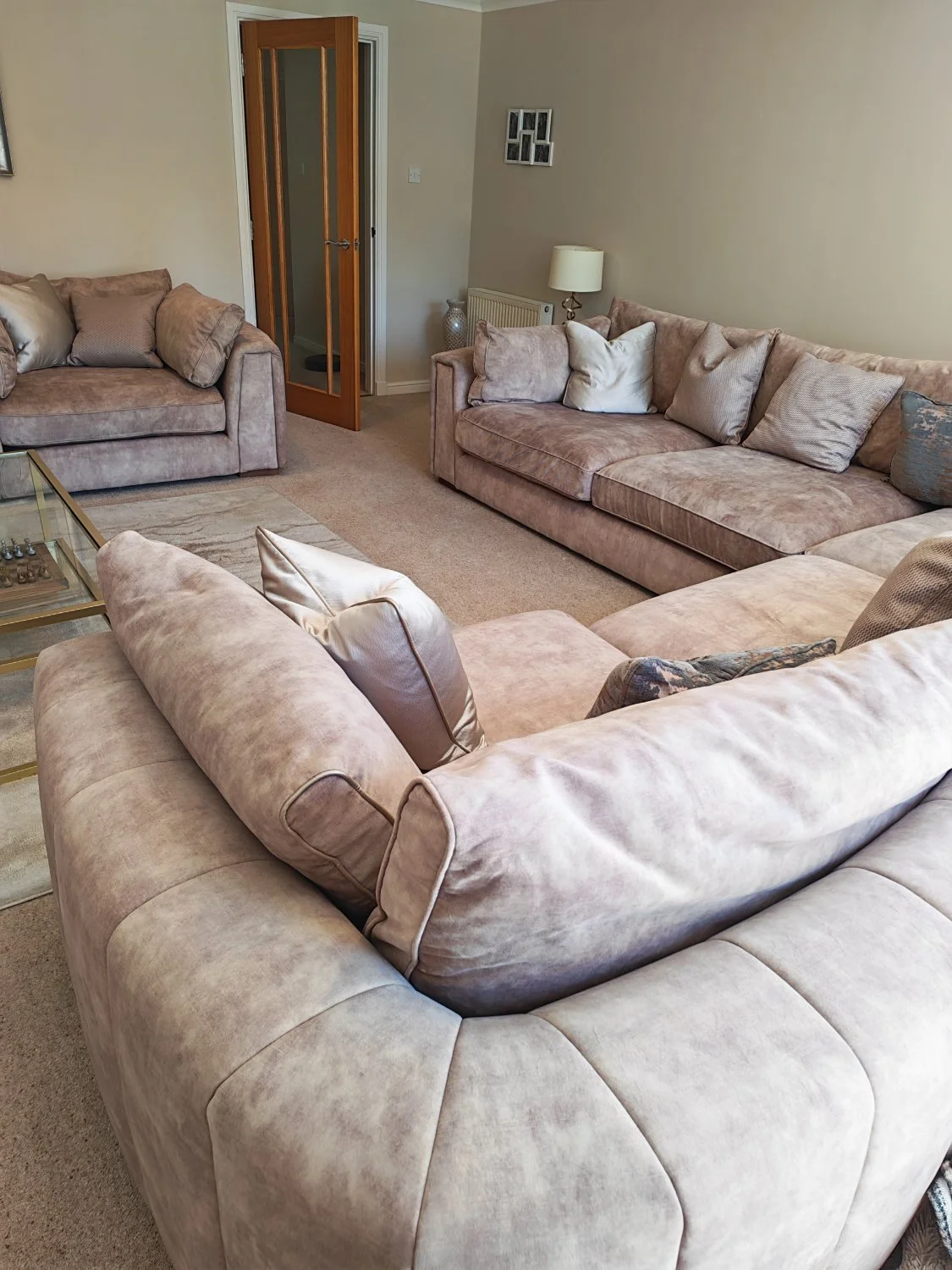 Large modern corner sofa in soft beige upholstery