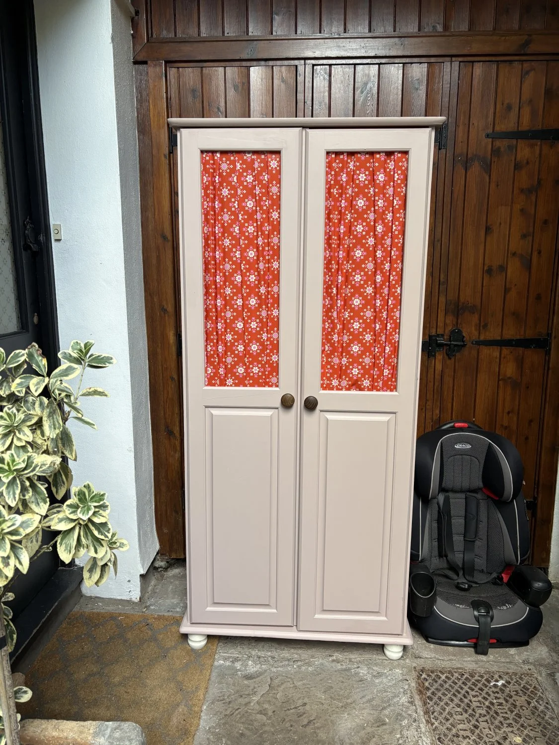 Two-door wardrobe with floral fabric panels