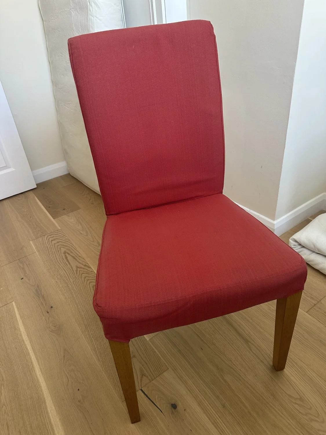 Modern red upholstered dining chair with wooden legs