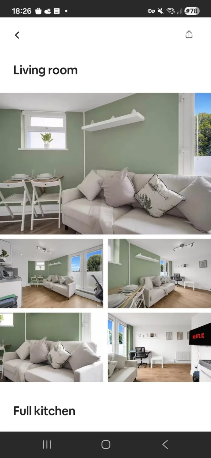Compact cream fabric two-seater sofa with loose back cushions