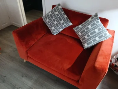 Two Rust orange fabric two-seater sofa with rounded arms and timber feet on Furnish Well