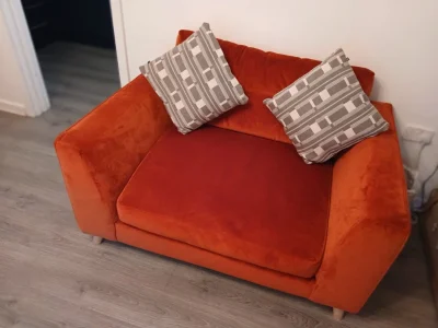 Two Rust orange fabric two-seater sofa with rounded arms and timber feet — image 2