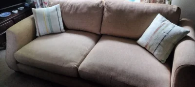 Modern two-seater sofa in warm taupe woven fabric with scatter cushions — image 2