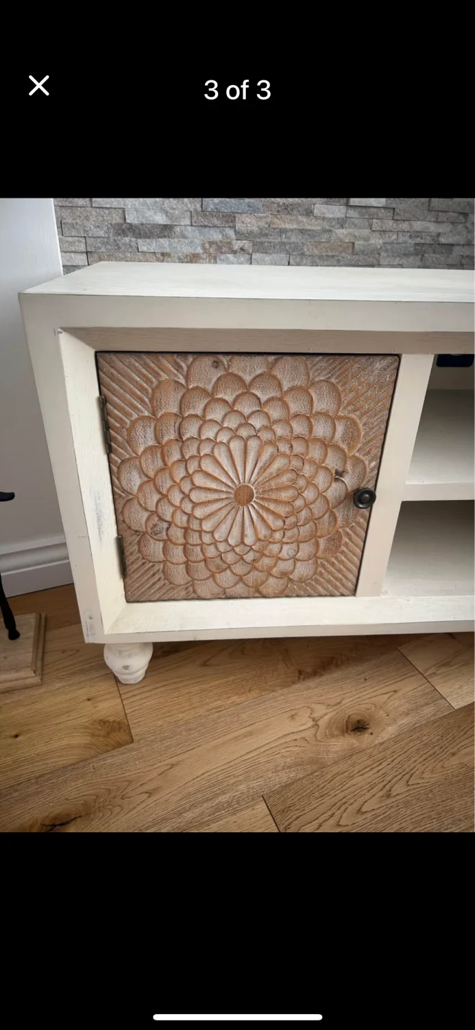 Cream TV media console with carved floral sliding cupboard doors