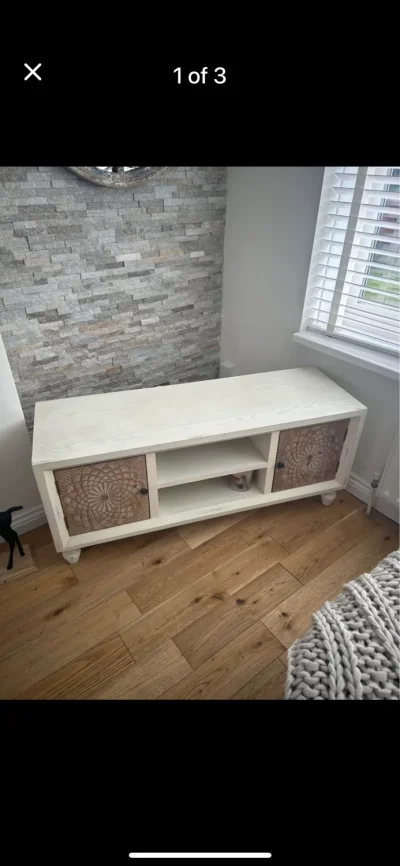 Cream TV media console with carved floral sliding cupboard doors — image 2