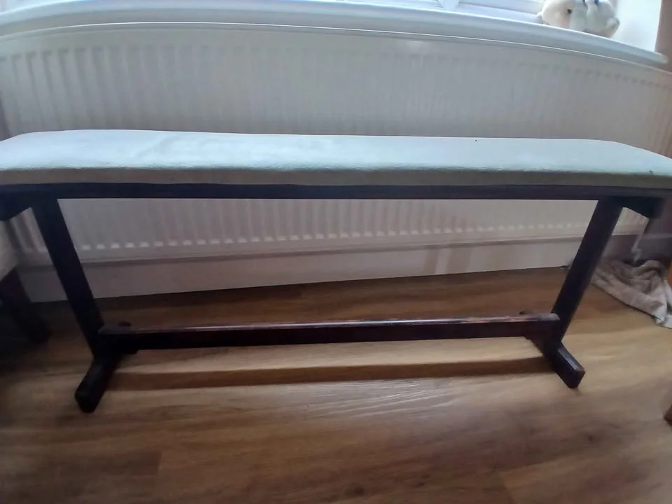Vintage dark wood piano bench with pale upholstered seat