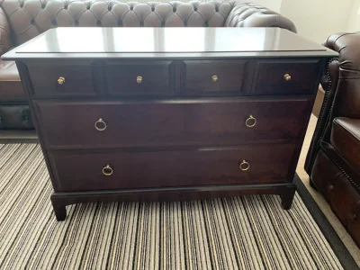 Dark mahogany-toned chest of drawers with brass ring handles — image 2
