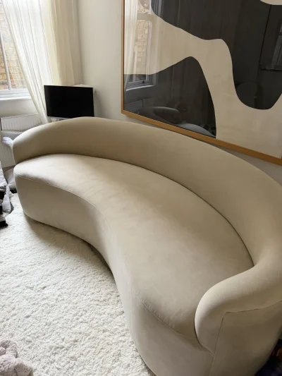 Large beige curved upholstered sofa with wraparound back — image 2