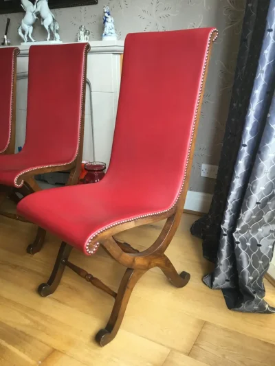Vintage dark wood trestle dining table with 6 red leather backed chairs — image 4