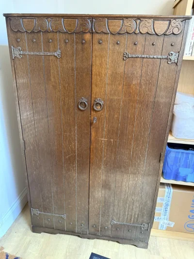 Vintage dark wood wardrobe with carved doors, hanging rail and shelves on Furnish Well