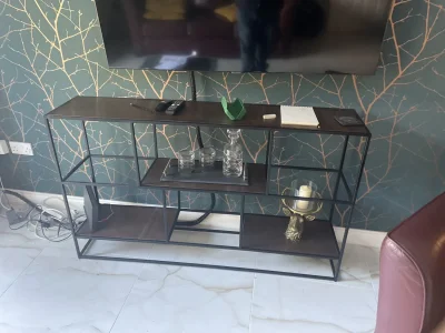 Black metal-frame open shelving media console with asymmetrical storage on Furnish Well