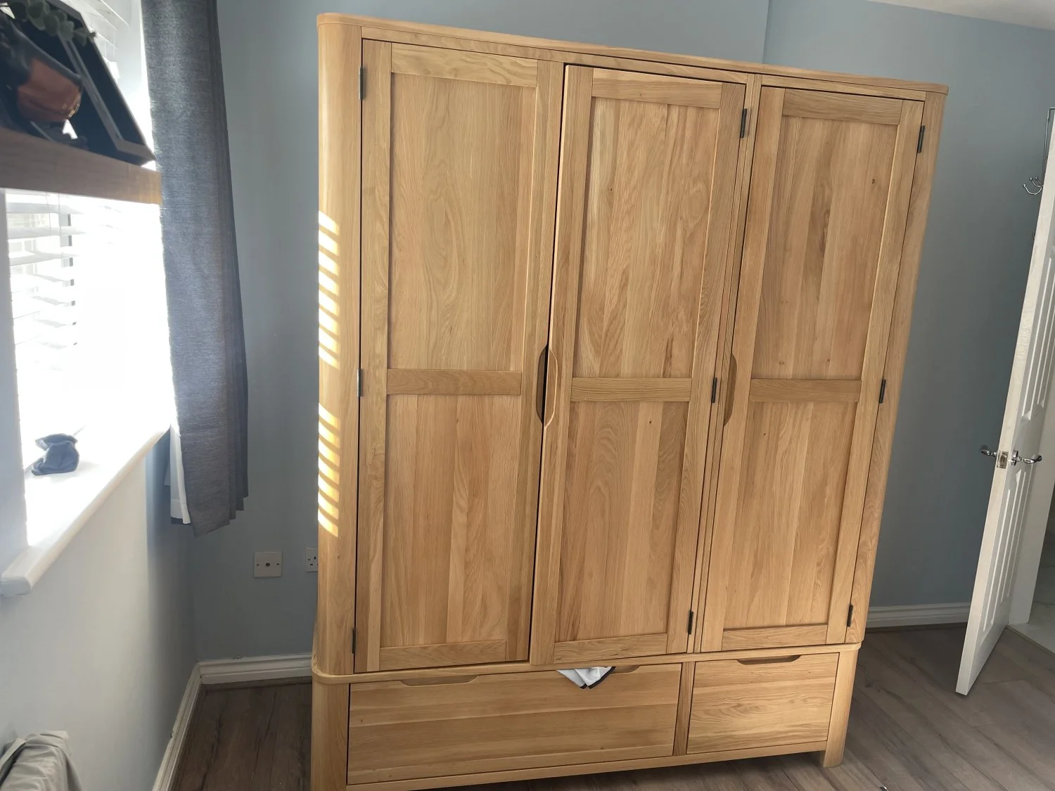 Large modern oak wardrobe with three doors, hanging rail and two drawers