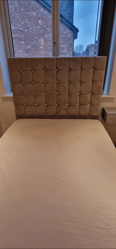Grey upholstered storage divan bed with tall button-tufted headboard — image 2