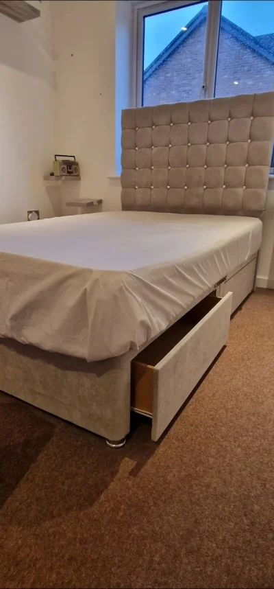 Grey upholstered storage divan bed with tall button-tufted headboard — image 4