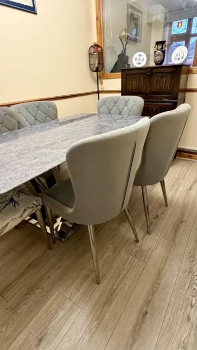 Contemporary grey marble-look dining table with six upholstered chairs — image 5