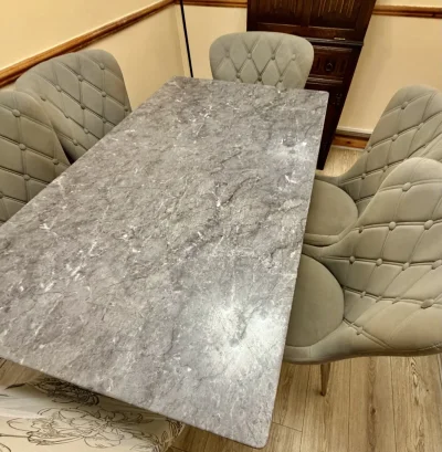 Contemporary grey marble-look dining table with six upholstered chairs on Furnish Well