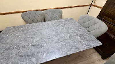 Contemporary grey marble-look dining table with six upholstered chairs — image 4