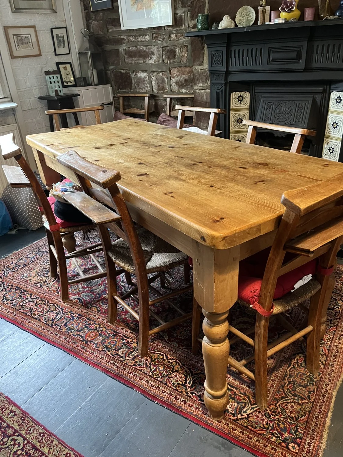 Vintage farmhouse pine dining table with turned legs and plank-style top